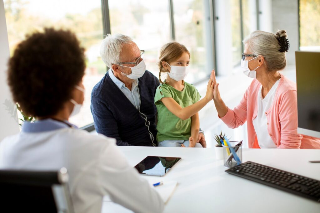 Senior couple with cute grandaughter black female doctor office 52137 35217